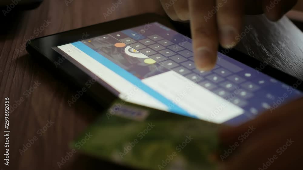 Shopping online with credit card on digital tablet pc. Closeup. Online banking with smartphone. Shopping online with credit card on digital tablet pc. Closeup. Online banking with smartphone.