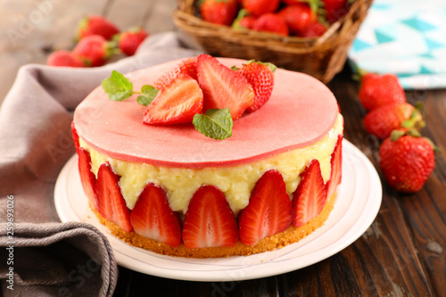 delicious strawberry cake on wood background