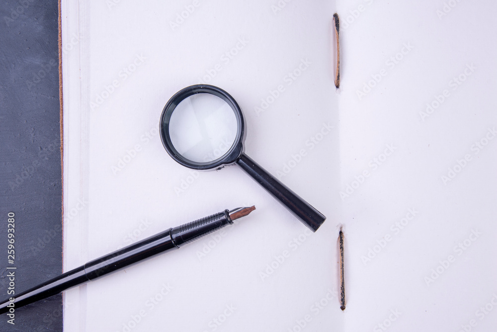 open empty book hand-bound with magnifying glass and fountain pen Stock ...