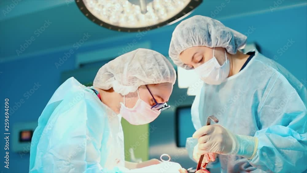 Surgeon at work. a team of professional surgeons performs surgery on the patient. Real operating room. Medical concept. close-up. Surgeon at work. a team of professional surgeons performs surgery on the patient. Real operating room. Medical concept. close-up.