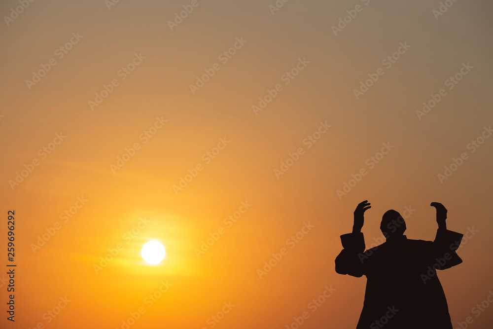 Fototapeta premium Muslims young pray for God in Ramadan with hope and forgiveness,Islam is a belief for the five-day prayer,Concept: Culture beliefs for mercy from heaven