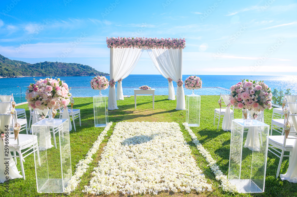 Wedding ceremony. Arch, decorated with flowers on the lawn, beach background,  sea in summer. Stock Photo | Adobe Stock