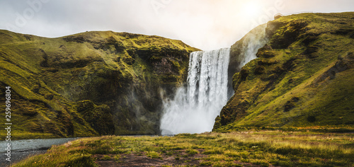 Fototapeta Naklejka Na Ścianę i Meble -  Beautiful scenery of the majestic Skogafoss Waterfall in countryside of Iceland in summer. Skogafoss waterfall is the top famous natural landmark and tourist destination place of Iceland and Europe.