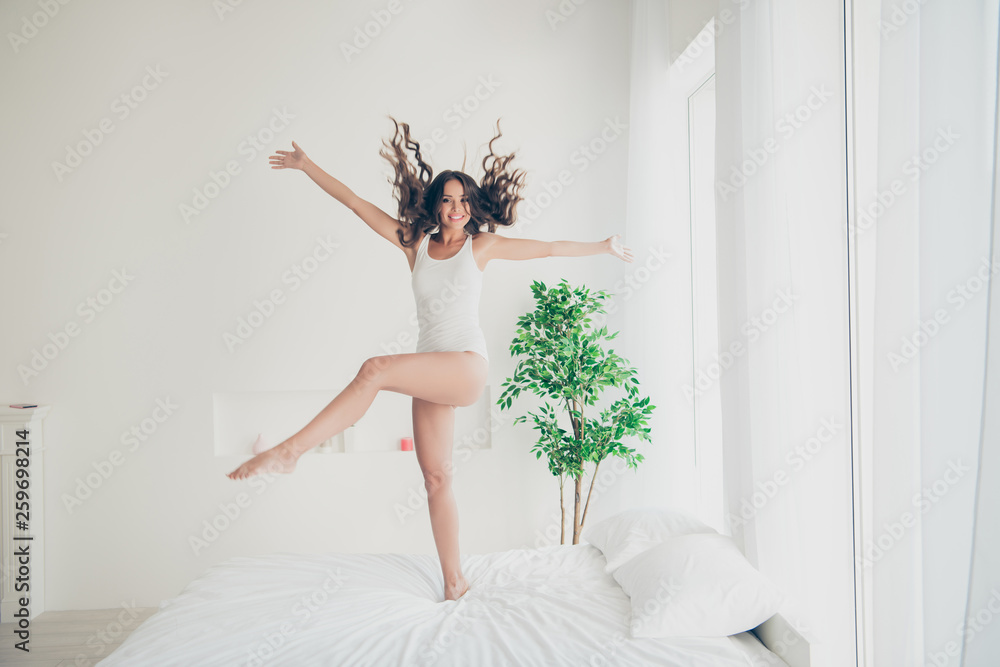 Fototapeta premium Full length body size view portrait of her she nice-looking attractive lovely charming cute cheerful cheery wavy-haired lady having fun free time in light white interior room indoors