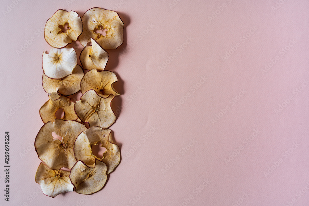 dried apples chips over red background. dried apples chips over red background.