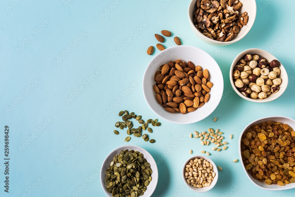 Superfoods in Bowls on blue Background. Superfoods in Bowls on blue Background.