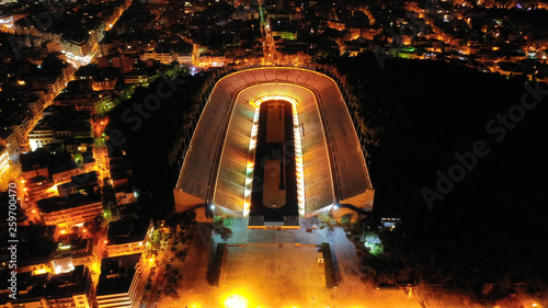 Fototapeta Naklejka Na Ścianę i Meble -  Aerial drone night shot of iconic illuminated ancient Panathenaic stadium or Kalimarmaro, Athens historic centre, Attica, Greece