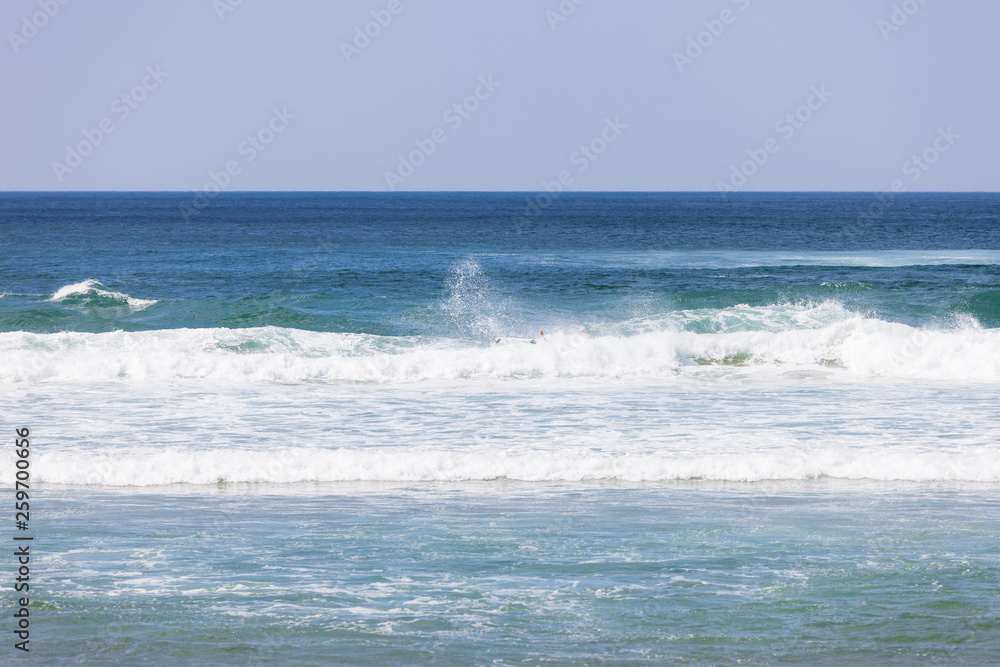Blue ocean waves. Breaking waves at sunny day. Tropical resort