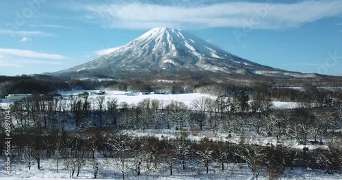 Aerial view of a large mountain in a snow covered landscape