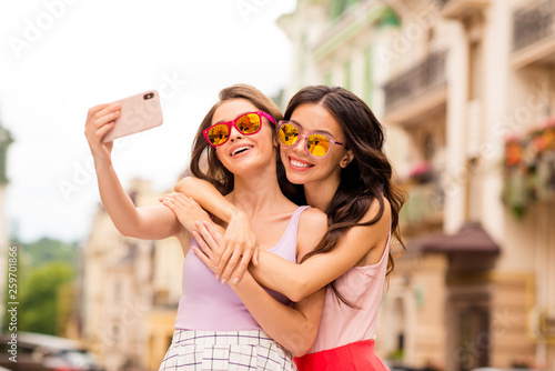 Portrait beautiful trendy cheerful bloggers people best students hairstyle travel stroll photos blog internet trip long hair bright eyewear eyeglasses spectacles cuddle  pastel clothing town center  photo