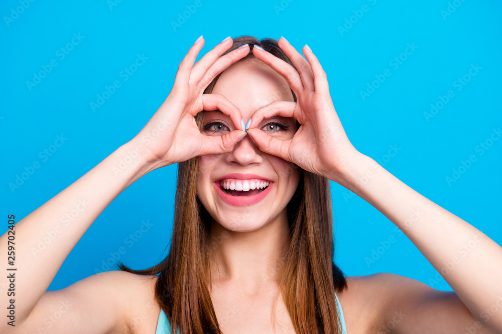Close up photo of lovely cute trendy college student advertising people recommending deciding fooling free time making eyewear with fingers feeling excited on bright background Close up photo of lovely cute trendy college student advertising people recommending deciding fooling free time making eyewear with fingers feeling excited on bright background