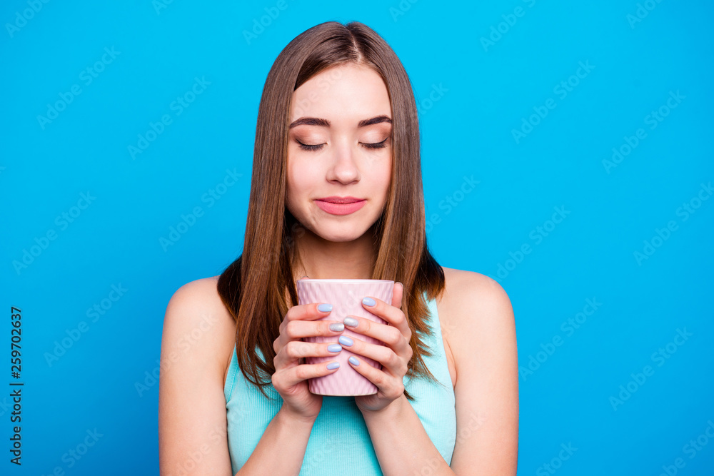 Portrait of pretty attractive lady holding hot drink cup shop feeling nice smell enjoying isolated having weekends holidays dressed in blue clothing on azure background Portrait of pretty attractive lady holding hot drink cup shop feeling nice smell enjoying isolated having weekends holidays dressed in blue clothing on azure background
