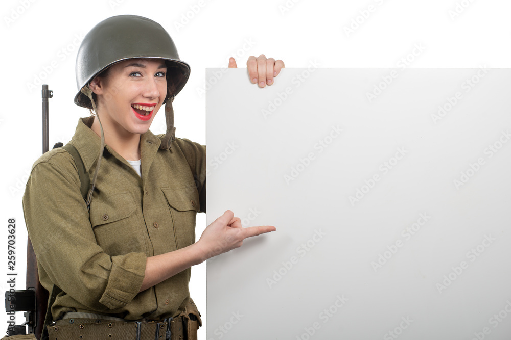 young woman dressed in American ww2 military uniform showing empty blank signboard young woman dressed in American ww2 military uniform showing empty blank signboard