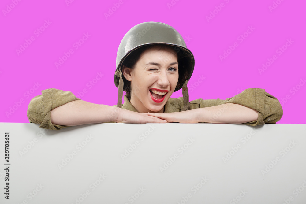 young woman dressed in American ww2 military uniform showing empty blank signboard young woman dressed in American ww2 military uniform showing empty blank signboard