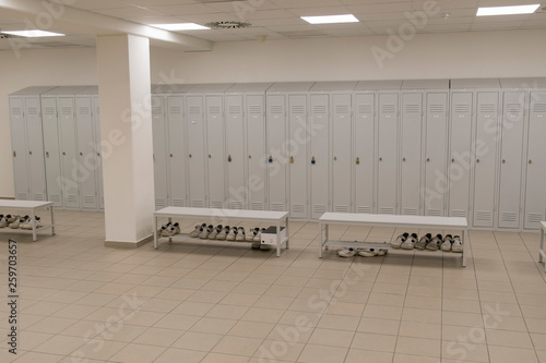 Bench with white work boots and lockers in the background.