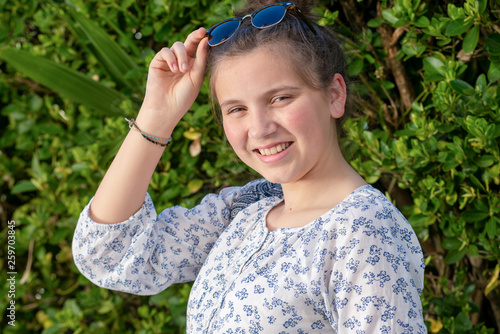 portrait of a young teen girl with  sunglasses outdoor
