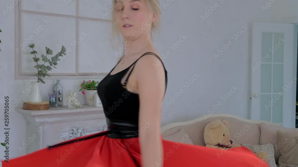 A young pretty girl is learning ballroom dancing in a bright and cozy city studio. Slow motion. A young pretty girl is learning ballroom dancing in a bright and cozy city studio. Slow motion.
