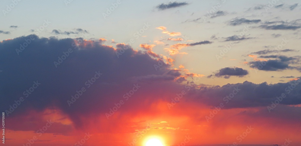 Panoramic view of beautiful fiery orange sunset background