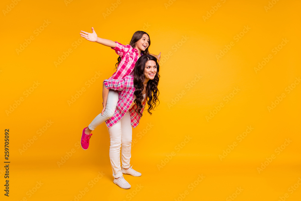 Full length body size view photo of charming mom little girl have free time stroll rest feel rejoice weekends holidays satisfied dressed in trendy checked shirts isolated on colorful background