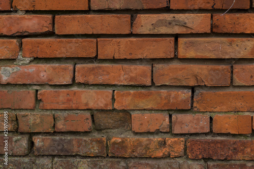 The brick texture  wall  with cracks and scratches can be used as a  background