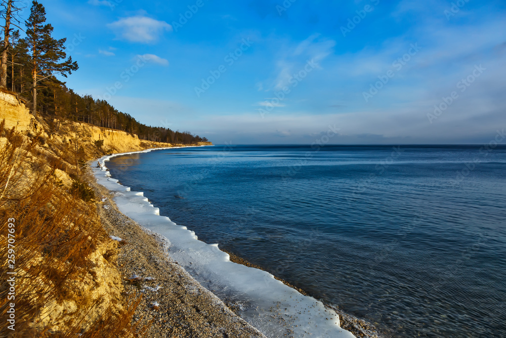 Coastline of Baikal lake in December with blue sky