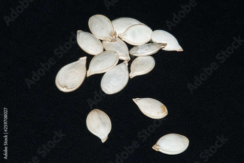 Pumpkin seeds, isolated on black background.