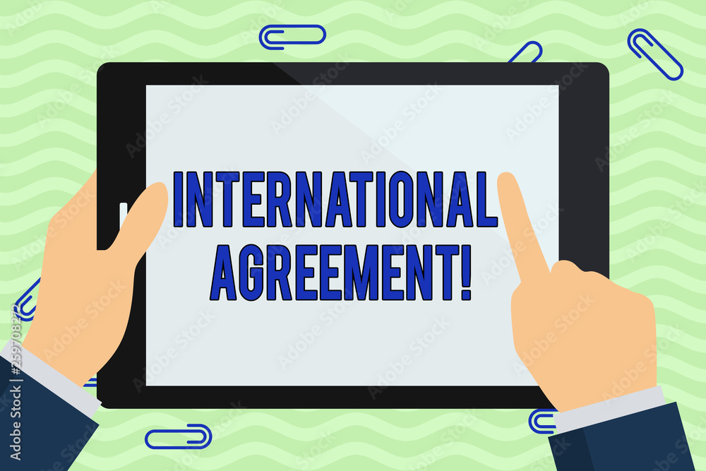 Writing note showing International Agreement. Business concept for document signed by countries want make new rules Hand Holding Pointing Touching Color Tablet White Screen Writing note showing International Agreement. Business concept for document signed by countries want make new rules Hand Holding Pointing Touching Color Tablet White Screen