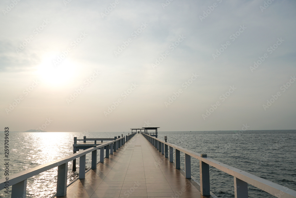 Fototapeta premium Wooded bridge in the port along sunrise at island beach.
