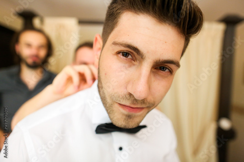 Photos Portrait of a groom getting ready for his wedding