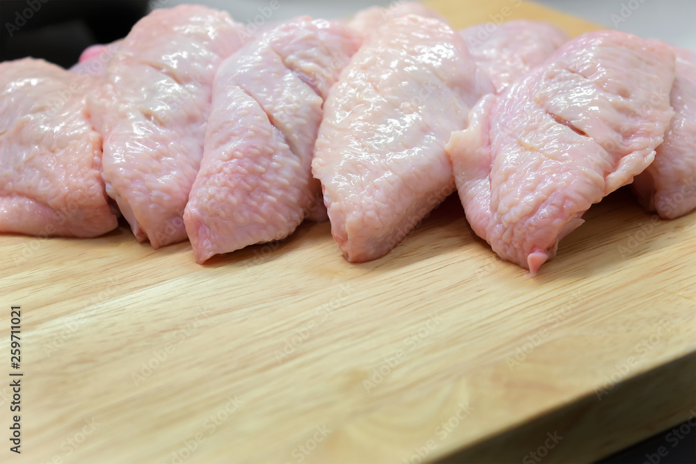 Raw Sliced Chicken Wings On a Wooden Cutting Board. Raw Sliced Chicken Wings On a Wooden Cutting Board.