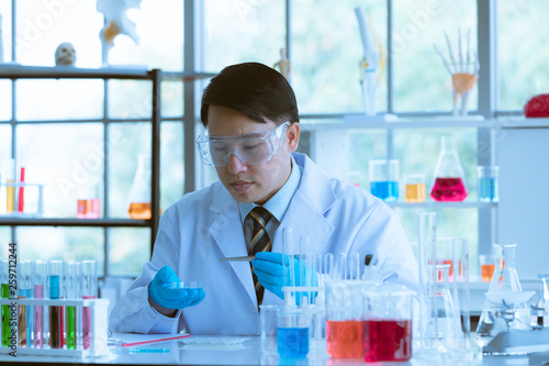 Male scientist collecting experimental samples.