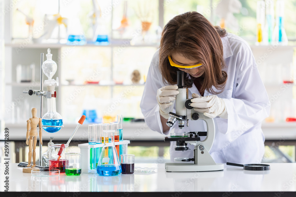 Scientist look through microscope for experiment.. Scientist look through microscope for experiment..