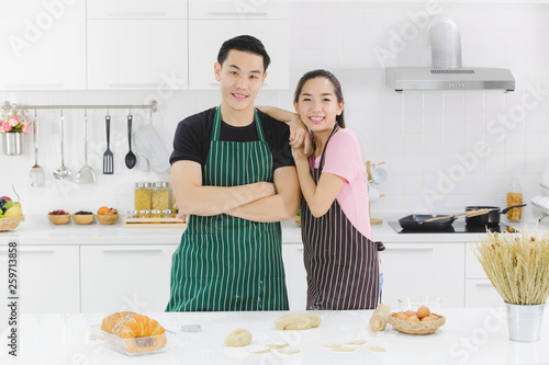 YOUNG COUPLE IN KITCHEN