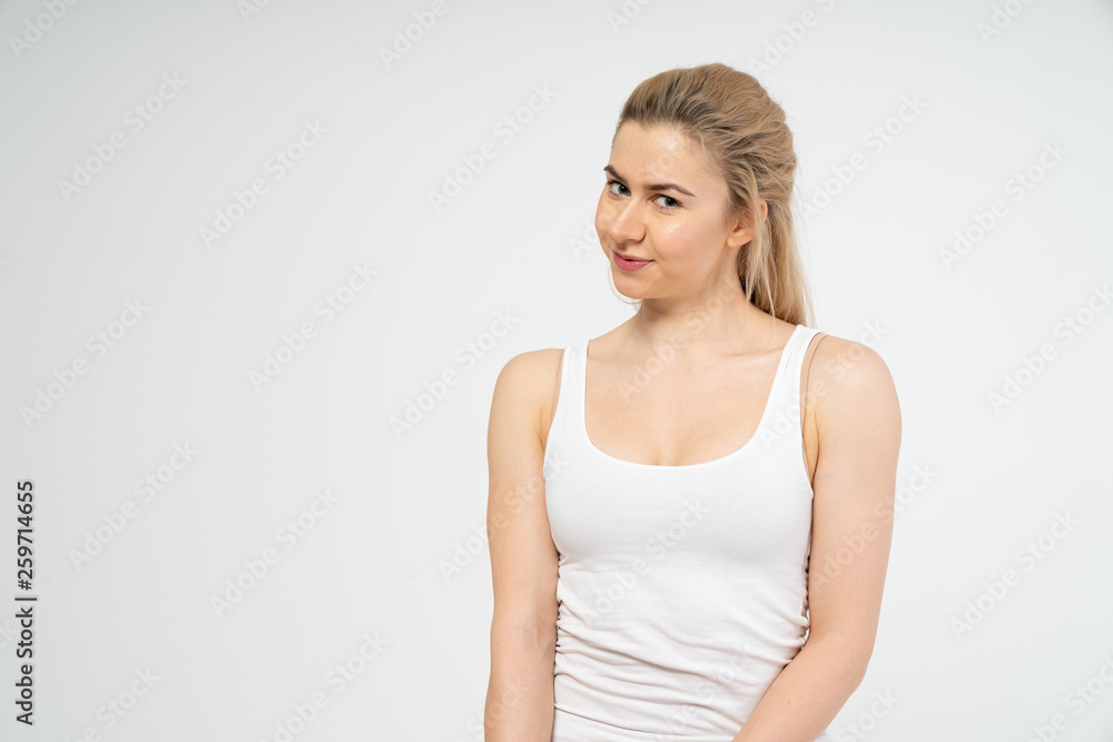 A young attractive girl is smiling and looking into the camera. Isolated on white background A young attractive girl is smiling and looking into the camera. Isolated on white background