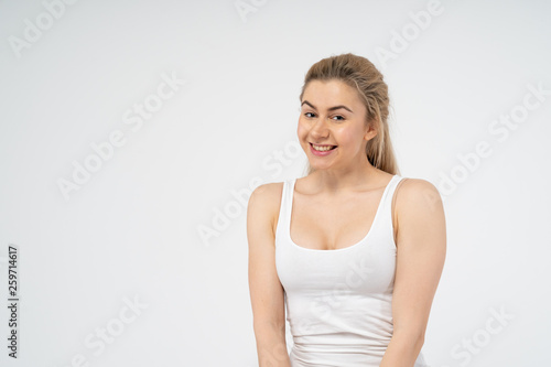 Young attractive girl is very happy, smiling and looking at the camera. Isolated on white background