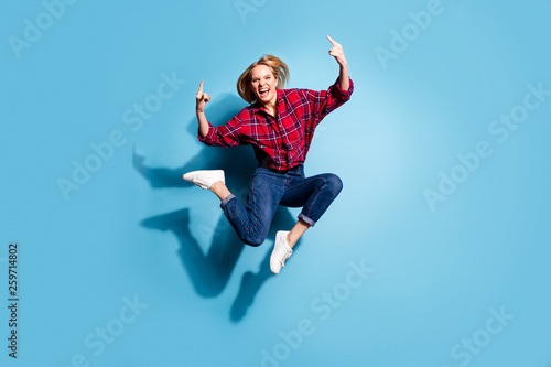 Full length body size view portrait of nice charming attractive cheerful cheery emotional girl wearing checked shirt showing horns sign isolated on teal turquoise bright vivid shine background