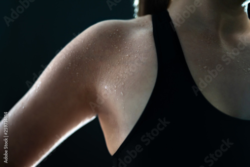 Sweaty woman after gym workout, heavy cardio or fat burning training. Sweat on wet skin. Tired fitness athlete, yoga instructor or personal trainer. Exhausted after exercise. Arm and armpit. Low key. © terovesalainen