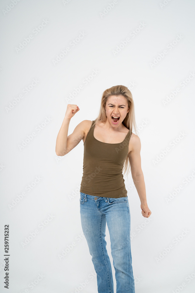 Young attractive girl is very happy and raises her hand up. Isolated on white background Young attractive girl is very happy and raises her hand up. Isolated on white background