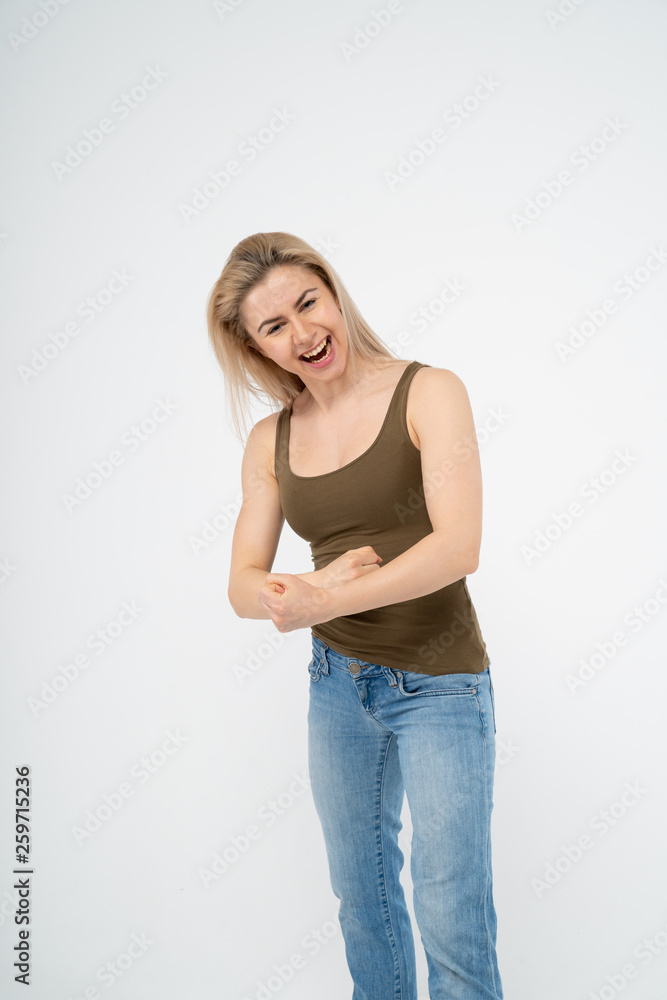 Young attractive girl smiles and shows her hands. Isolated on white background Young attractive girl smiles and shows her hands. Isolated on white background