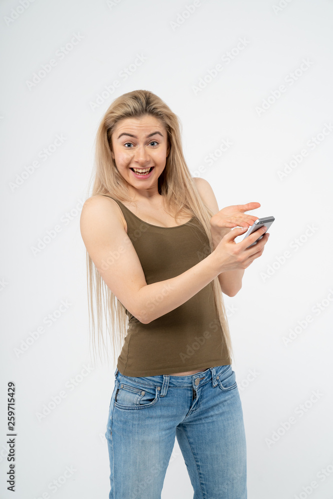 Young happy girl is surprised and looking at the camera. Isolated on white background Young happy girl is surprised and looking at the camera. Isolated on white background