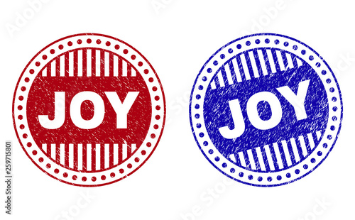 Grunge JOY round watermarks isolated on a white background. Round seals with grunge texture in red and blue colors. Vector rubber watermark of JOY caption inside circle form with stripes.