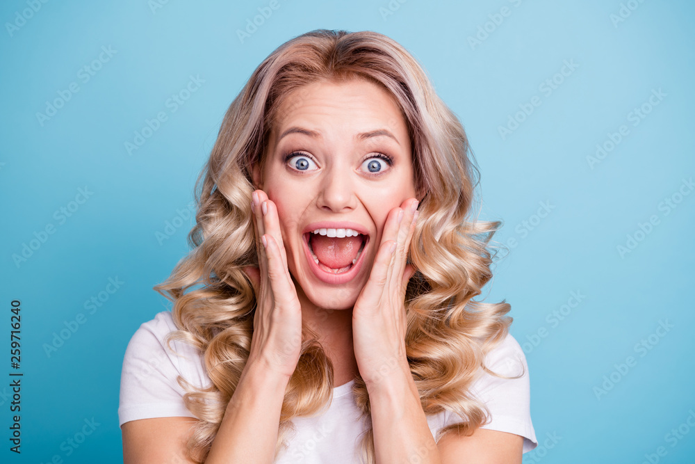 Close up photo beautiful yelling loud her she lady hands arms palms touch cheeks cheekbones eyes full fear wear casual white t-shirt jeans denim clothes outfit isolated bright blue background Close up photo beautiful yelling loud her she lady hands arms palms touch cheeks cheekbones eyes full fear wear casual white t-shirt jeans denim clothes outfit isolated bright blue background