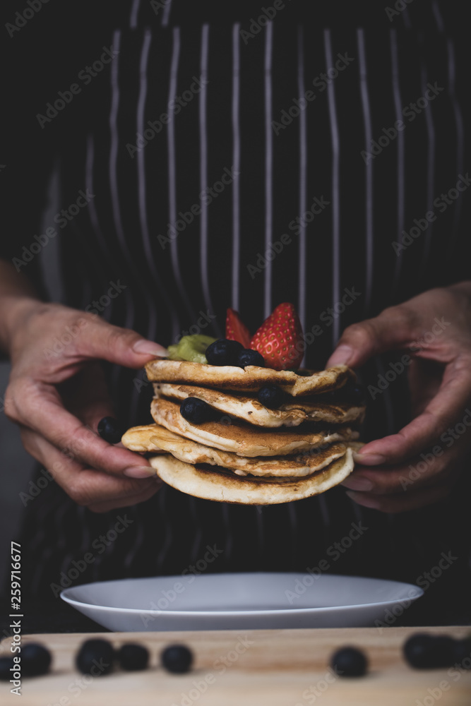 Woman preparing pancakes Woman preparing pancakes