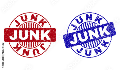 Grunge JUNK round stamp seals isolated on a white background. Round seals with grunge texture in red and blue colors. Vector rubber overlay of JUNK text inside circle form with stripes. photo