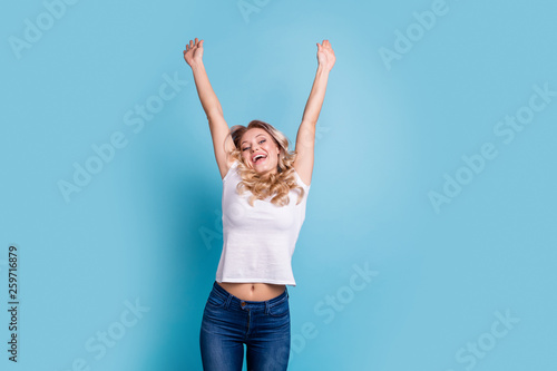 Close up photo beautiful funky her she lady hands arms palms fists raised up air above head satisfied lucky facial expression wear casual white t-shirt jeans denim clothes isolated blue background