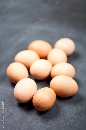 Farm organic chicken eggs on black background.