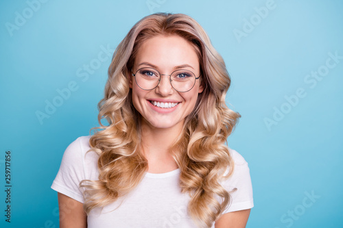 Close-up portrait of her she nice-looking lovely sweet winsome attractive cheerful cheery pretty wavy-haired lady wearing casual white tshirt isolated on blue pastel background photo