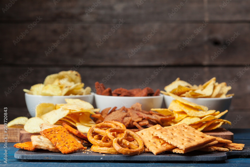 wide selection of snacks for beer on wooden background wide selection of snacks for beer on wooden background