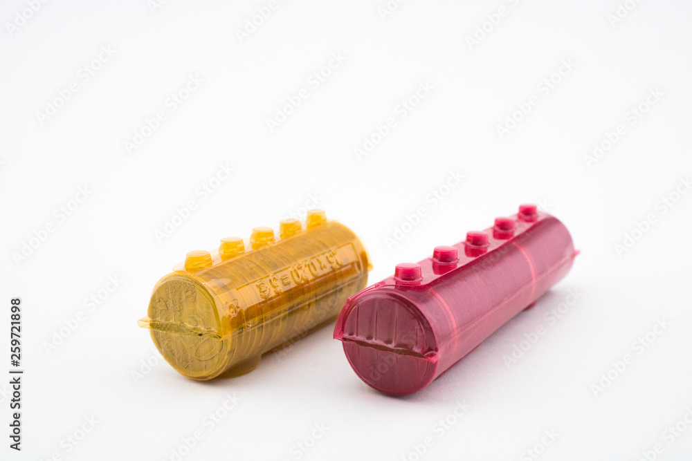 Rolls with coins of twenty euro cents and five euro cents, white background. Rolls with coins of twenty euro cents and five euro cents, white background.