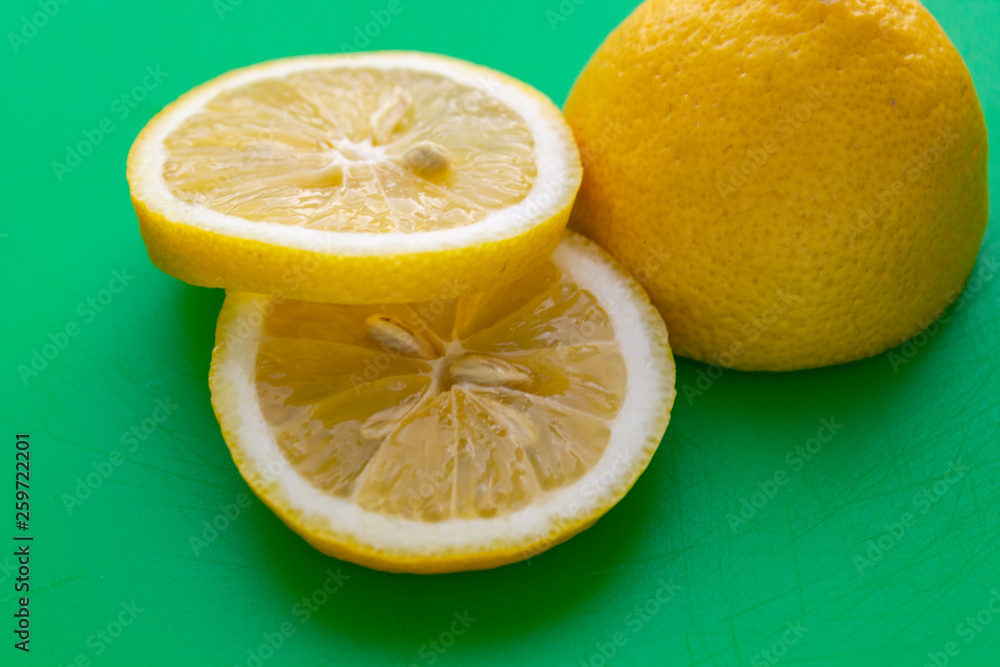 sliced lemon on green background sliced lemon on green background
